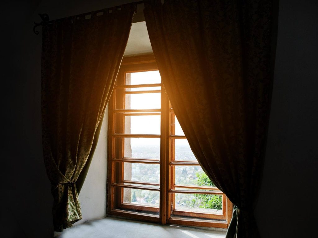 wood-ancient-window-with-curtains-dark-room-with-sunlight